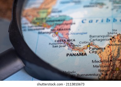 Panama on a world map through magnifying glass. Panama travel destination planning pinned