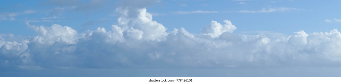 Panaramic clouds in a blue sky.