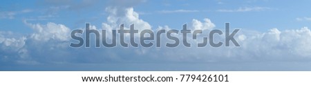 Panaramic clouds in a blue sky.