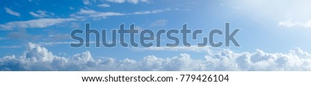Panaramic clouds in a blue sky.