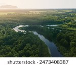 Panaramic view from a height of a flying drone on a summer landscape. Lake and river, field and forest.