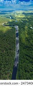 Panaramic view from a height of a flying drone on a summer landscape. Lake and river, field and forest.