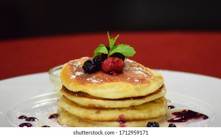 pancake with fresh berry sauce and maplesyrup