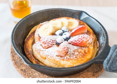 pancake with fresh strawberry blueberry and banana  on pan