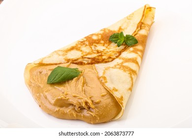 Pancake With Peanut Butter Served Mint Leaves