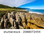  Pancake Rock is a natural wonder of New Zealand. Incredible journey to the ends of the world. Stone flat "pancakes", stacked on top of each other. The concept of ecological, active and photo tourism