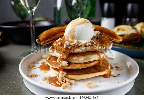 Pancakes with\
banana, caramel and ice cream\
scoop