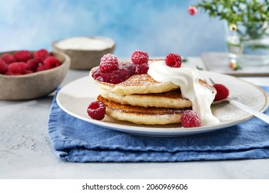 Pancakes For Breakfast With Sour Cream, Raspberry Jam And Fresh Raspberries.