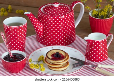 Pancakes With Currant Jam On Plate And Red Tea Set