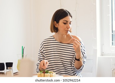 pancakes are delicious and very tasty, and young girl wearing striped marina blouse is excited to about this delicious dish - Shutterstock ID 1052962214