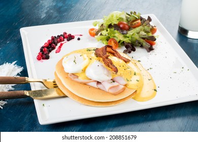 Pancakes With Eggs Benedict On Blue Background