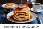 Pancakes: Fluffy, golden-brown pancakes stacked high and served with maple syrup and a pat of butter. A breakfast favorite that