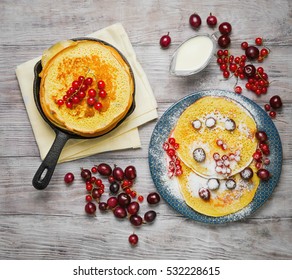  Pancakes Fritters In Cast Iron Skillet Stack, Hash Browns Pancakes On Plate With Berries. Berries For Pancakes Crepes Red Currants, Gooseberries, Cherries, Sour Cream. White Background. Top View.