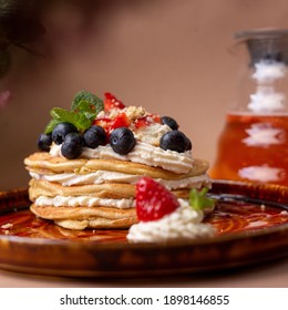 pancakes with fruit tea on a cream background
