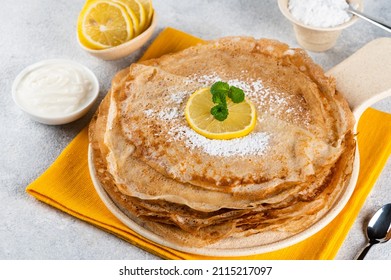Pancakes with lemon and sugar. Traditional for Shrove Tuesday. Pancake day. Pancakes with lemon juice and powdered sugar. Russian Maslenitsa. Sweet crepes. shrovetide holiday