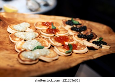 A Lot Of Pancakes With Red, Black And White Caviar