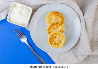 Pancakes With Sour Cream Frozen Blueberries And Raspberries.