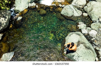 Pance River In Cali, Colombia. Top View Shot Of A Young Man Enjoying Trip To A Clear Water River And Nature At The Farallones National Park.