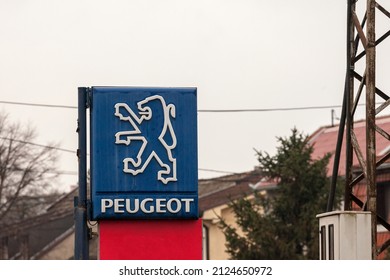 PANCEVO, SERBIA - MARCH 21, 2022: Peugeot logo on an old sign of a car dealership of the brand, with distinctive Lion. Peugeot, part of PSA group, now stellantis, is one of main french car producers