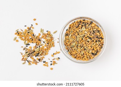 Panch phoron  or panchpuran  Indian and Bengal five spice seeds  blend for cooking  consisting of fenugreek, fennel, cumin, mustard seeds, onion seeds or black cumin in bowl on white background  - Shutterstock ID 2111727605