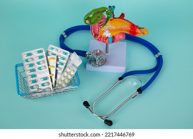 pancreas and stethoscope with a basket of pills lies on a blue background - Shutterstock ID 2217446769