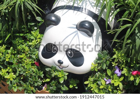 A panda statue in a garden