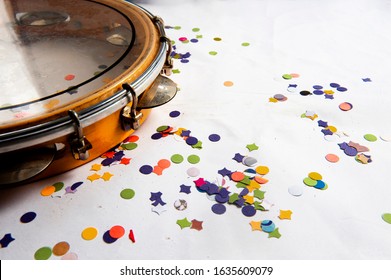 Pandeiro, traditional samba instrument, used in the Brazilian carnival. White background, paper confetti. Seen from above. Space for text. Horizontal. - Shutterstock ID 1635609079
