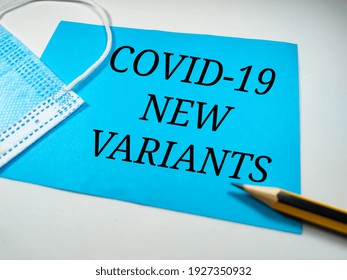 Pandemic concept.Text COVID-19 NEW VARIANTS on white background with face mask and pencil. - Shutterstock ID 1927350932