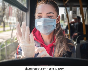 Pandemic COVID-19. A woman in a medical mask and gloves rides public transport bus. Prohibition of free movement. Social distance. Coronavirus quarantine in Europe.