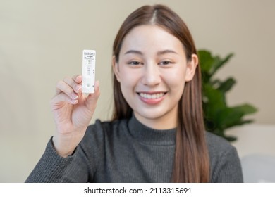 Pandemic Of Disease, Smile Asian Young Woman, Girl Hand Show Holding Atk, Antigen Kit Self Test. Introducing Device Nasal, Nose Swab Test For Possible Infection Of Corona, Covid At Home. Health Care.