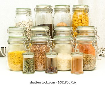 Pandemic pantry with stocked food.  Emergency food prep during Coronavirus Covid-19 for survival. Supplies you need at home if you are quarantined. Prepping for quarantine - glass jars with provision. - Shutterstock ID 1681955716