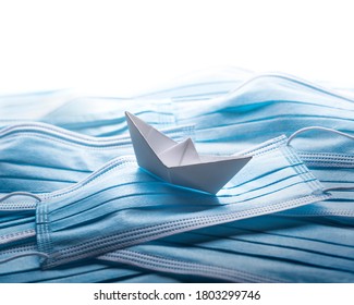 Pandemic problems concept, origami ship with surgical masks. - Shutterstock ID 1803299746