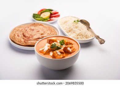 Paneer Butter Masala Or Cheese Cottage Curry Served With Rice And Laccha Paratha