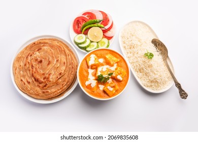 Paneer Butter Masala Or Cheese Cottage Curry Served With Rice And Laccha Paratha