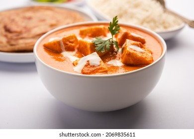 Paneer Butter Masala Or Cheese Cottage Curry Served With Rice And Laccha Paratha