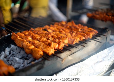 Paneer Fish Chicken Tikka Roasting On An Open Hearth With Glowing Coals And Smoke Coming Out. A Staple Of Indian Cusine As A Starter Or With Roti Naan Bread And A Very Spicy Marination. North Indians