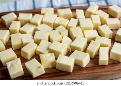 Paneer Or Indian Cottage Cheese Cubes On A Wooden Chopping Board. Selective Focus.