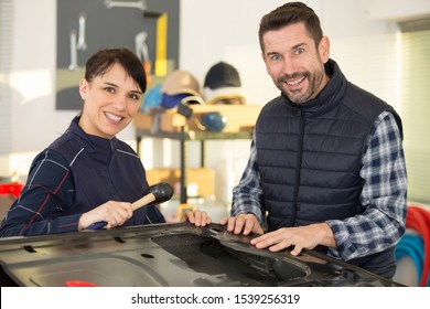 panel beating team in a garage - Powered by Shutterstock