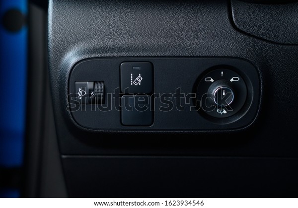 Panel  for\
controlling mirrors in a new car, function for tracking road\
markings. Close up of a control panel in a new modern car.\
Headlight control console in a new modern\
car.