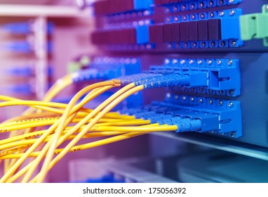 Panel of Fiber network switch with some yellow network cables - Shutterstock ID 175056392