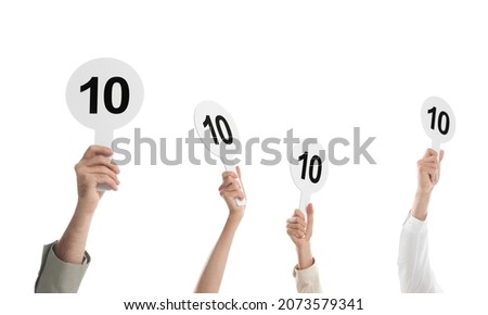 Panel of judges holding signs with highest score on white background, closeup