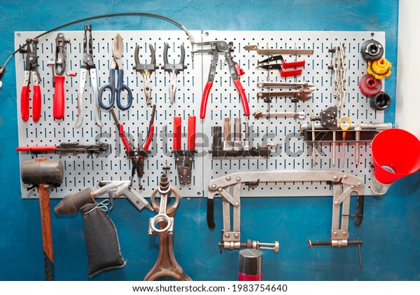 Panel with special tools for car repair on the\
wall of a car service