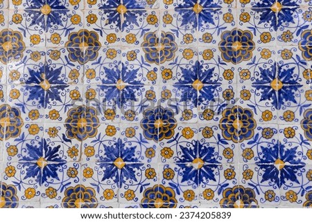 Panel with traditional blue and yellow Portuguese azulejos tiles with floral repeating motifs and patterns, decorative wall art, Toledo, Spain.
