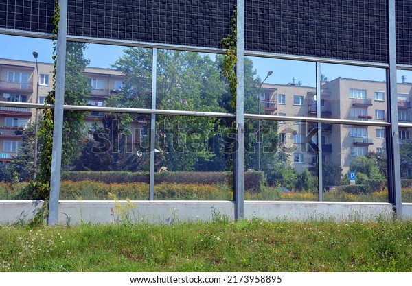 Panels against noise cars - view of apartment\
blocks through panel\
windows