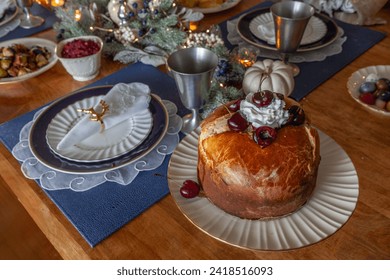 Panettone bread with cherries and whipped cream on a holiday table at Christmas.