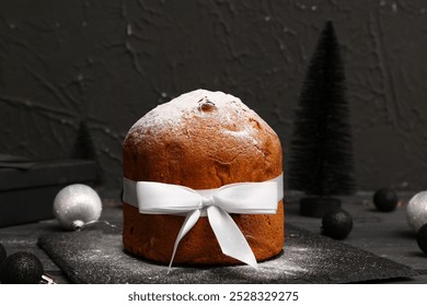 Panettone sprinkled with powdered sugar on black background - Powered by Shutterstock