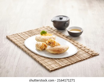 Pan-fried Chilli Crab Dumpling with sauce served in a dish isolated on mat side view on grey background
