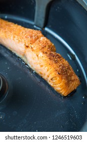 Pan-fried Piece Of Salmon With Spices In The Fryer. Skin Down Salmon Frying. Close Up Picture Of Fried Salmon. Dark Grey Frying Pan. Air Fryer Salmon.