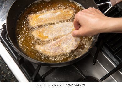 Pan-frying or home cooking fish fillet on a stove top.