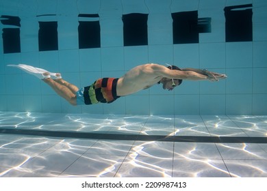 Panglao, Philippines - 20.04.2022: Male Freediver Training In The Pool Wearing Short Fins Holding Breath 